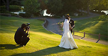 Fotograf macht Aufnahmen vom Hochzeitspaar im Park Fotograf macht Aufnahmen vom Hochzeitspaar im Park